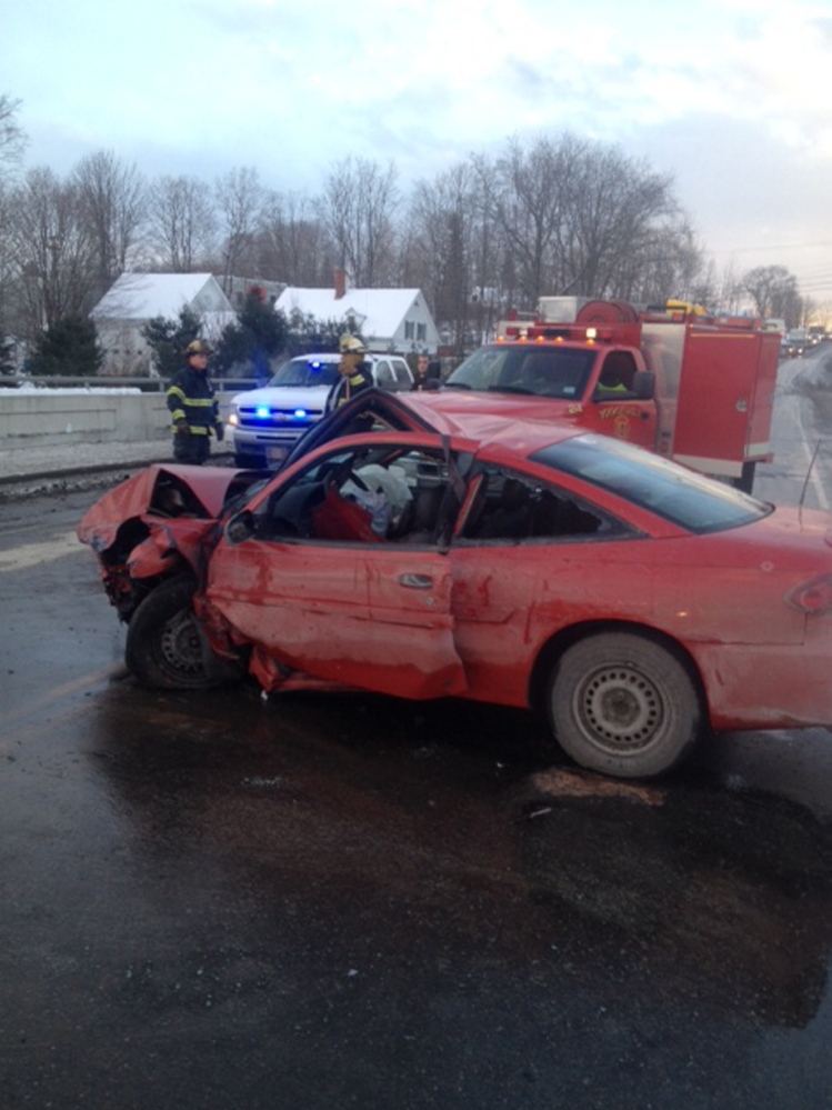 Norridgewock Fire Department crews and a Somerset County Sheriff’s deputy await a tow truck Friday afternoon following the two-vehicle crash on the Kennebec River bridge on U.S. Route 201A in Norridgewock.The road was closed to traffic for more than an hour. Two people were taken to the hospital.