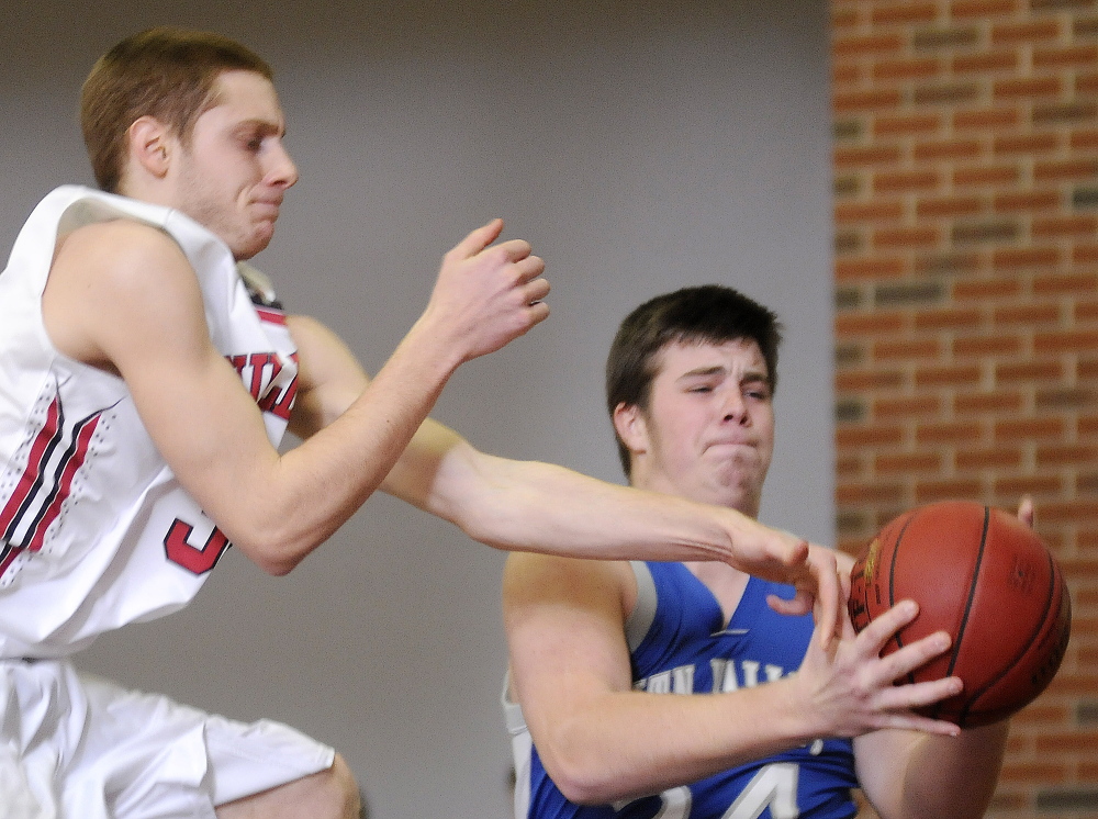 Hall-Dale High School’s Wesley LaPointe, left, loses a rebound to Mountain Valley High School’s Caleb Gauvin during a Mountain Valley Conference game Tuesday night in Farmingdale.