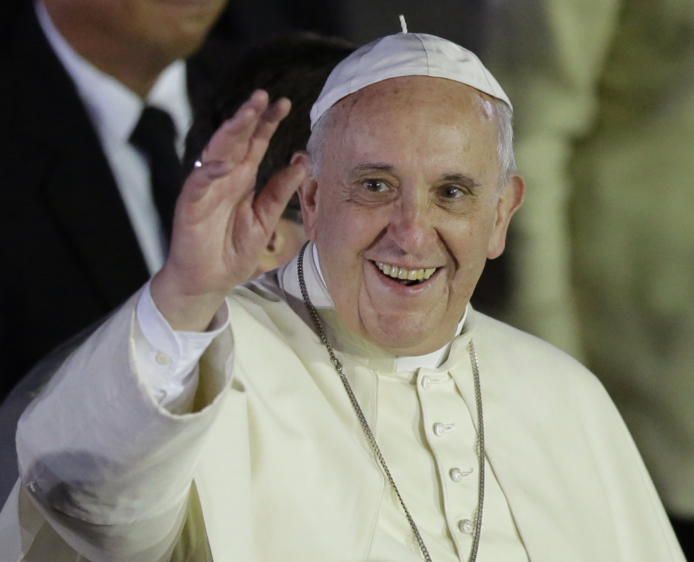 Pope Francis waves to well-wishers upon arrival from Sri Lanka on Thursday at suburban Pasay city, south of Manila, Philippines. Ecstatic crowds greeted the pontiff as he arrived Thursday in the Philippines, Asia’s most populous Catholic nation, for the first papal visit in 20 years.