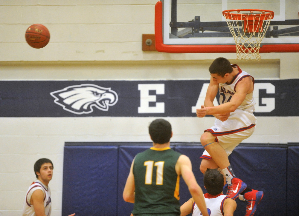 Staff photo by Michael G. Seamans 
 Messalonskee High School's Nick Mayo, right, rejects a shot during a Kennebec Valley Athletic Conference Class A game Friday night against Oxford Hills.
