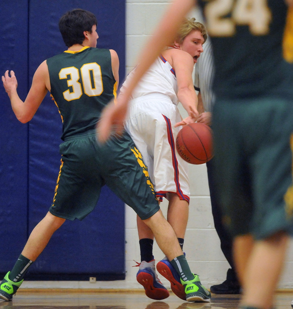 Messalonskee’s Taylor Turner, right, saves the ball from going out of bounds as Oxford Hills’ Patrick Marco defends Friday night.