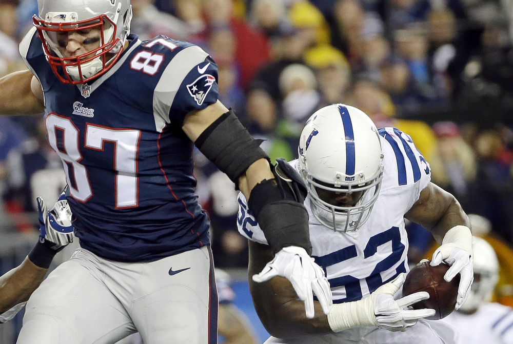 Indianapolis Colts inside linebacker D’Qwell Jackson (52) intercepts a pass intended for New England Patriots tight end Rob Gronkowski during the first half of the AFC championship game last week in Foxborough, Mass. The NFL is investigating whether the Patriots deflated footballs that were used in their victory over Colts.