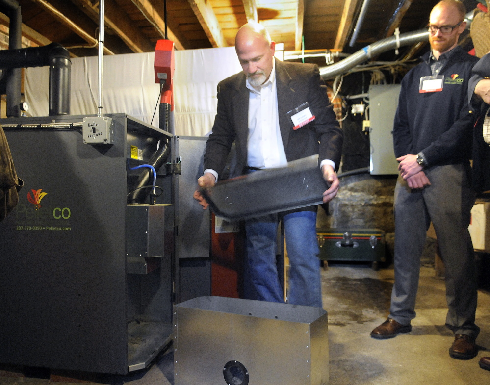 ReVision Heat managing partner Lee Landry displays components of a pellet boiler Wednesday that was installed recently at Maple Hill Farm Inn in Hallowell. Landry and Nathan LaCroix, right, of Pelletco, were part of a team that helped the bed-and-breakfast and meeting center convert to pellets in an effort to save money while using a local heat source.