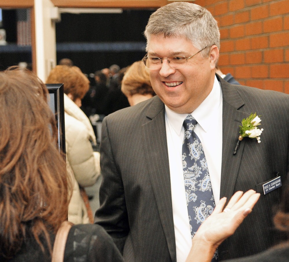 Ross Cunningham, the new Kennebec Valley Chamber of Commerce new president and CEO, greets people entering the annual awards banquet at the Augusta Civic Center.