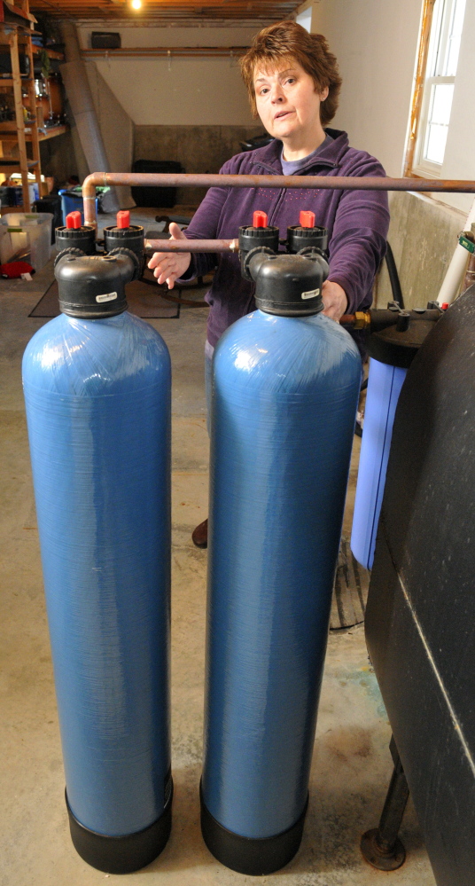 Andrea Brann talks about the point-of-entry water filtration system in her family’s home on Thursday in Manchester.