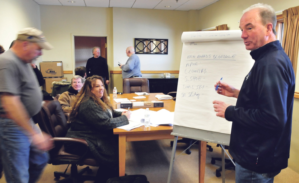 Philip Geelhoed, president and CEO of Special Olympics Maine, outlines on Sunday changes to events for this year’s Special Olympics Maine Winter Games at Sugarloaf ski resort. Tuesday events have been moved to Monday because of the impending snowstorm. At left is Lisa Bird, director of public relations.