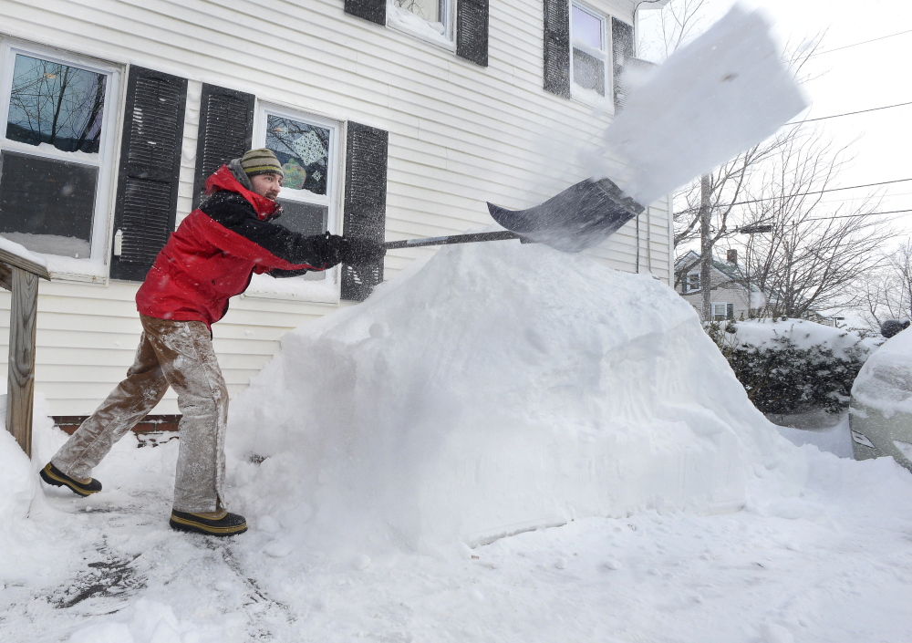 Nick Rofe on Wednesday whittles away at a snowy embankment outside his home in Gorham, which got almost 2 feet of new snow and the deepest drifts of the season during Tuesday’s blizzard. Meanwhile, a winter storm watch is in effect starting Thursday night and lasting until early Saturday morning.