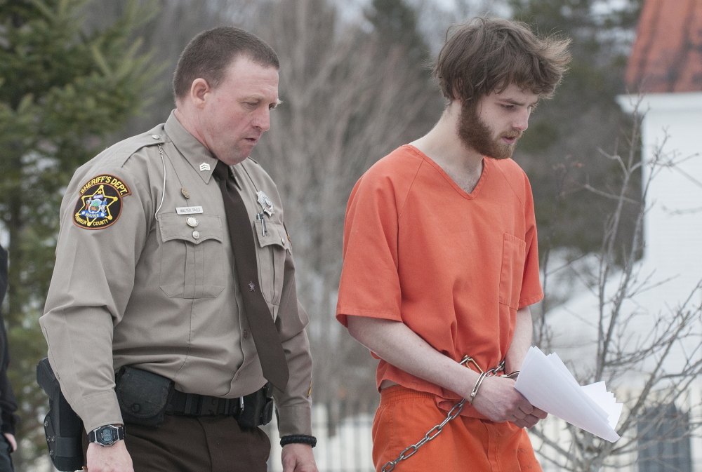 Dana Craney, right, is escorted to a waiting jail transport by Franklin County Sheriff Deputy Walter Fail after Carney’s initial appearance in Franklin County Superior Court in Farmington on last month.