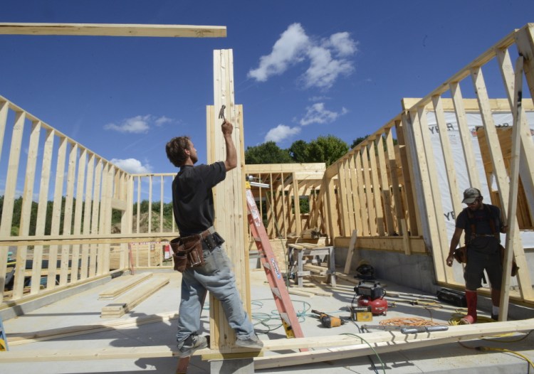 A crew works on a new home in Gorham last summer. Recent employment statistics from an industry group ranked Maine 48th in the country for construction job growth.