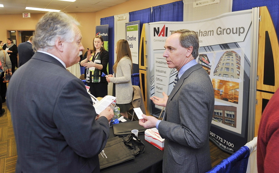 Charles Craig, with the NAI Dunham Group, right, talks business with Jack Carr, senior vice president of Criterium Engineering, at the annual MEREDA forecasting conference Thursday at the Holiday Inn by the Bay in Portland. Gordon Chibroski/Staff Photographer