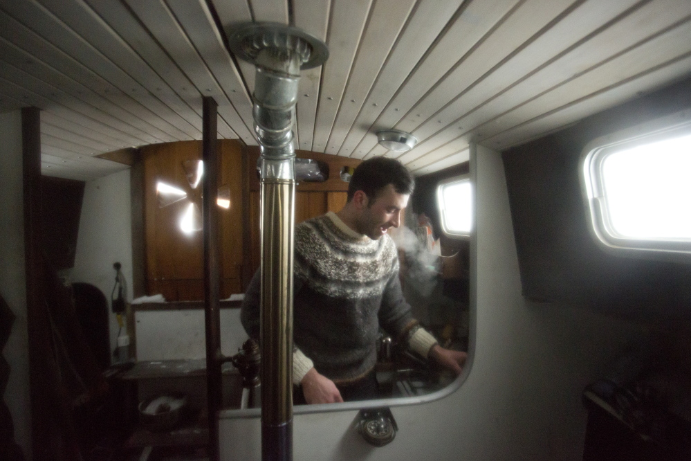 Jack Marrie makes coffee aboard his boat. Marrie said people offer him a place to stay on land during storms, but he prefers the boat in case something goes wrong. “It doesn’t take anything really remarkable” to live on a boat, he said.