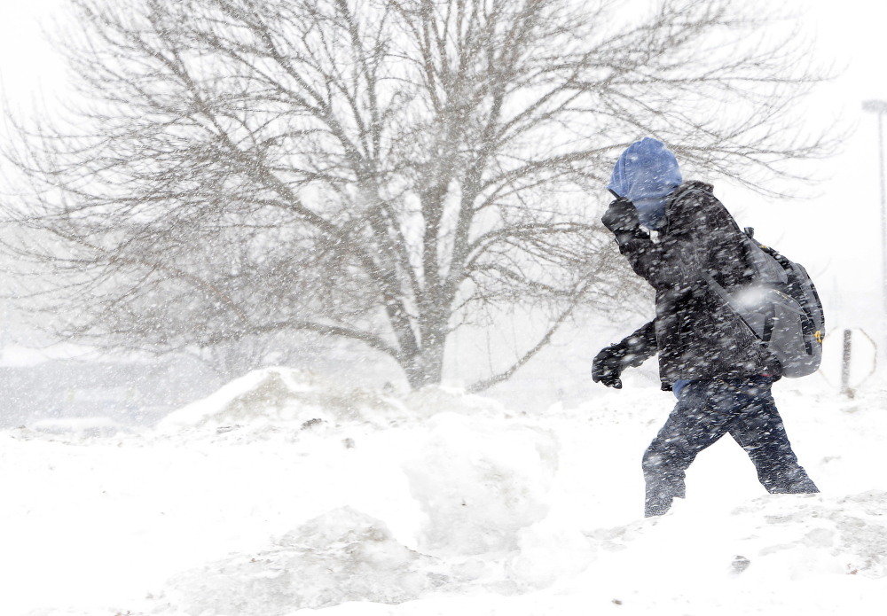 Jacob Poole braces against the wind and snow Monday as he walks along Preble Street Extension in Portland. Temperatures stayed in the single digits, and wind gusts created a chill that made it feel like 10 to 20 below zero in southern parts of the state.