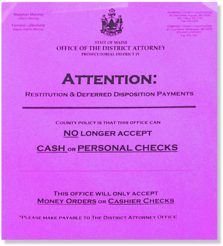A sign at the Kennebec County Courthouse notifies people that they can no longer use cash when paying restitution or supervision fees to the district attorney’s office in Kennebec or Somerset counties.