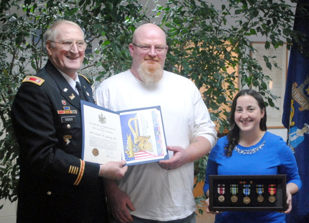 Contributed photo 
 Peter Ogden and Claire Bridgeo present Gerry with his medals.