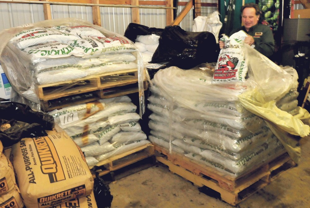 Aubuchon Hardware store manager Mario Bisol pulls out a bag of one of the varieties of coal sold at the Skowhegan store. The company sells different size coal products including blacksmith, rice, nut and pea coals.