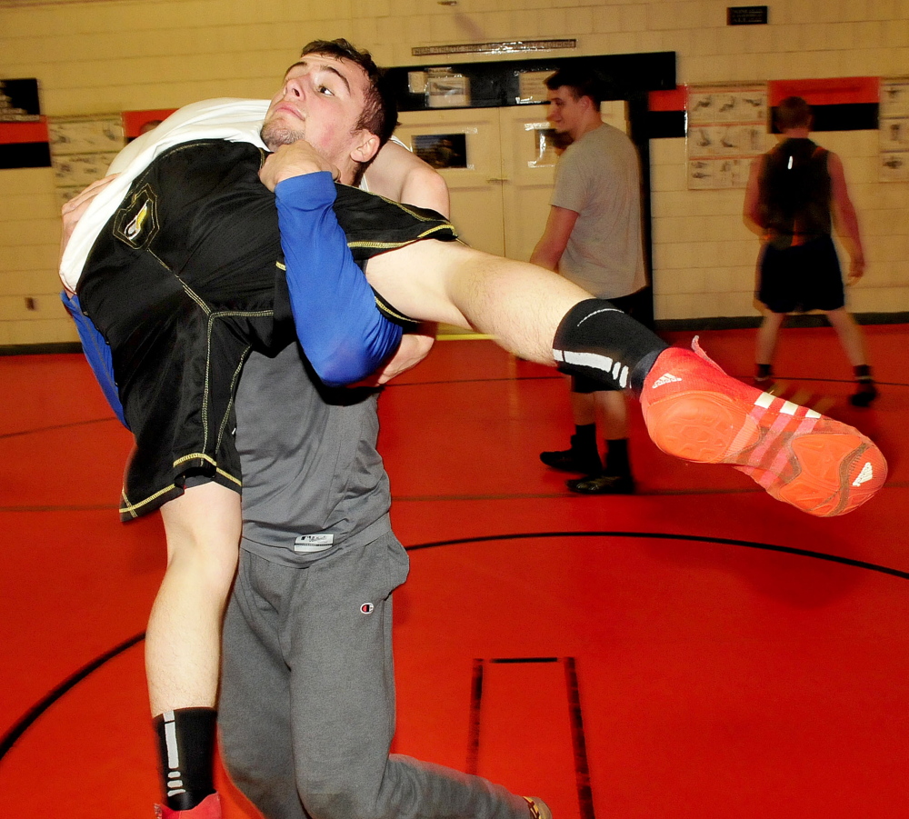 Skowhegan wrestler Kameron Doucette, right, throws teammate Julian Sirois during practice Tuesday at Skowhegan Area High School.