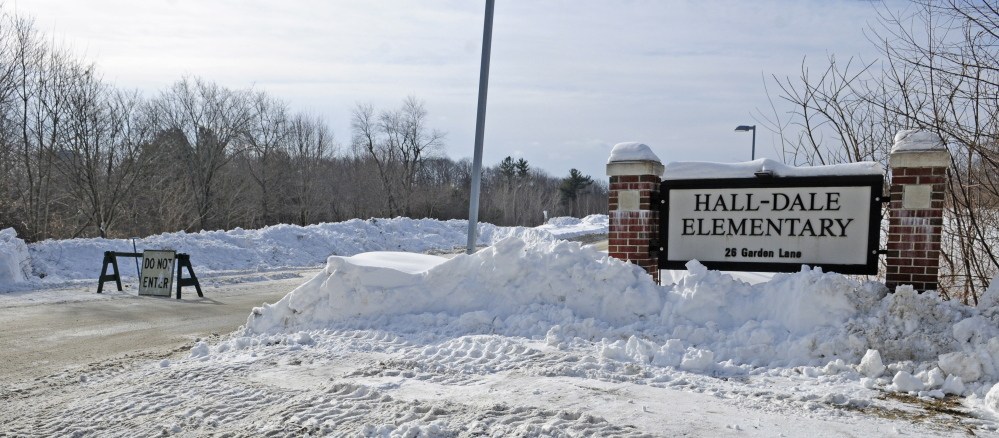 A barricade stands at the driveway to Hall-Dale Elementary at the corner of Winthrop Street and Garden Lane in Hallowell where a wrench sticks up from a natural gas line shutoff valve around 10 a.m. on Saturday.