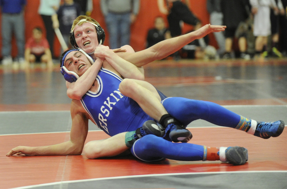 Maine Sunday Telegram photo by John Ewing 
 Fryeburg Academy wrestler Patrick Duffy gets Erskine's Justin Studholme locked up during a 138-pound match at the Western B championships Saturday at wells.