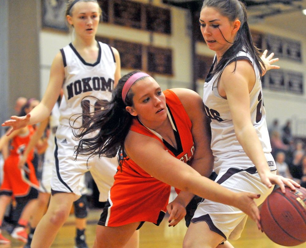 Winslow’s Hannah Doble, center, tries to pass as she is defended by Nokomis’ Jessica Cloutier, right, in the second half last week in Newport. The teams will play again as Nokomis finished seventh in Eastern B and will host the No. 10 Black Raiders.