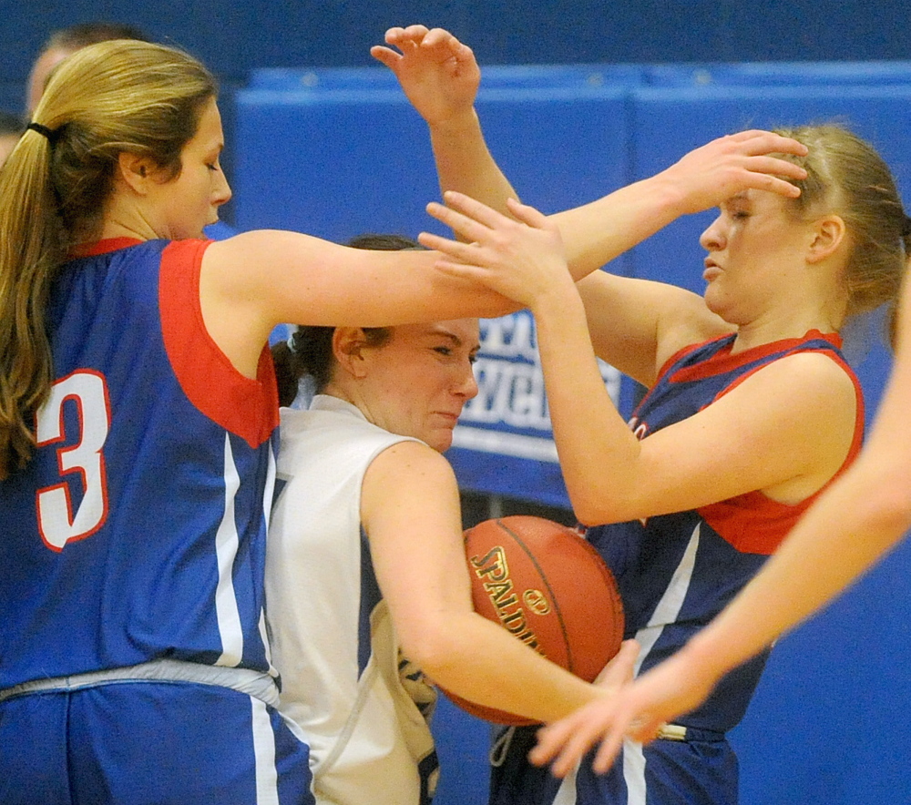 Lawrence High School’s Emily Tozier, middle, has little room to move as she draws Messalonskee defenders Sophie Holmes, left, and Haley Lowell in an Eastern A game last week. The rivals will square off again Friday at the Augusta Civic Center in a regional quarterfinal game.