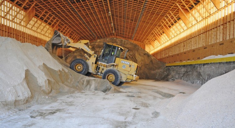 A worker mixes salt and sand on Friday at the John Charest Public Works facility in Augusta. Public works staffers spent part of their Friday shifts preparing equipment for the storm forecast to hit the area this weekend.
