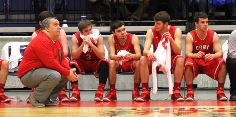 Cony High School coach T.J. Maines and his players react during the waning minutes of an 89-51 loss to Lewistonin an Eastern A quarterfinal Monday morning at the Augusta Civic Center.