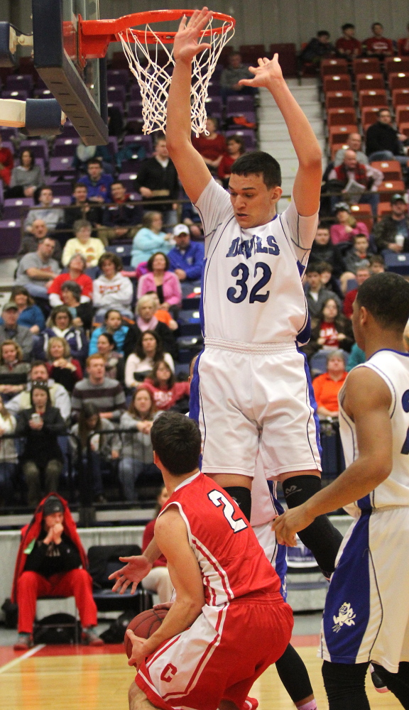 Lewiston High School’s Trevor Irish looks down at Cony High School’s Tyler Carrier before committing a foul in the second half of the Blue Devils’ 89-51 win over the Rams in an Eastern Maine Class A quarterfinal at the Augusta Civic Center on Monday.