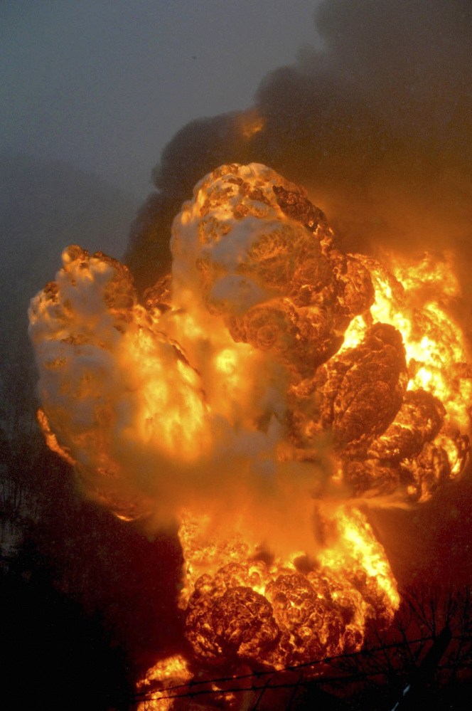 A fire burns Monday, after a train derailment near Charleston, W.Va.