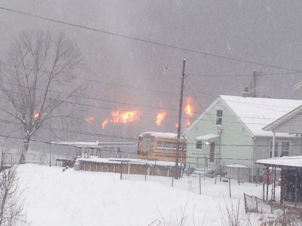 A fire burns Monday, after a train derailment near Charleston, W.Va.