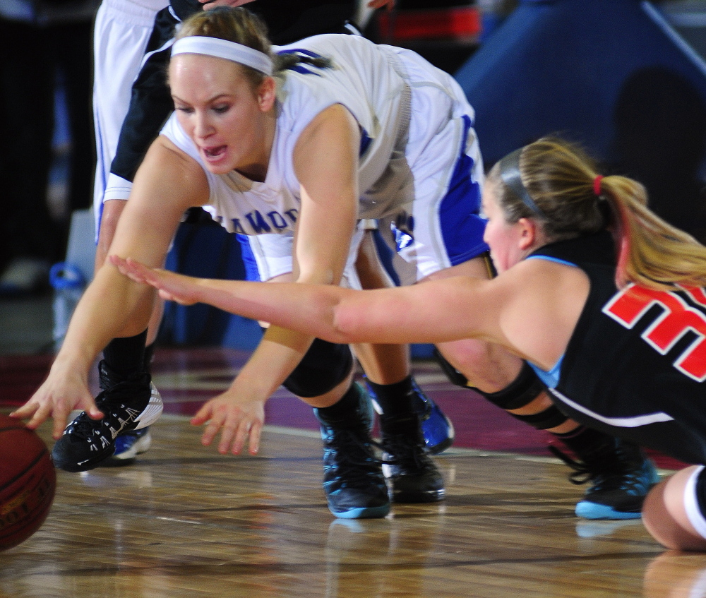 Lawrence’s Nia Irving dives after a loose ball contested by Brunswick’s Kolby Levesque during an Eastern A semifinal game Wednesday at the Augusta Civic Center.