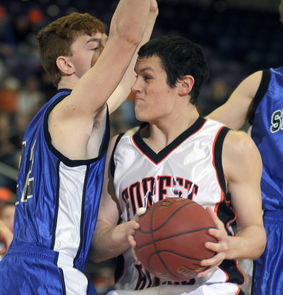 Forest Hills’ Matt Turner, right, looks for an opening around Seacoast Christian’s Sky Archer during a Western D semifinal Wednesday at the Augusta Civic Center. Turner and the top-seeded Tigers will face No. 3 Hyde in the Western D final Saturday at 2:45 p.m.