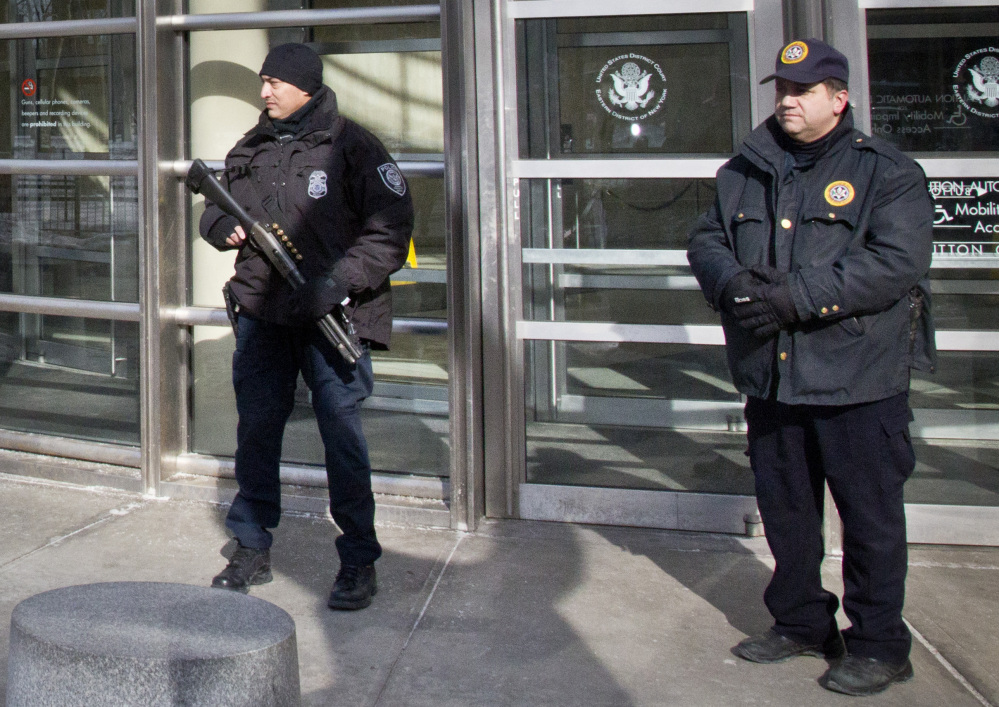 A Homeland Security police officer, left, joins a federal court policeman as security is enhanced during the arraignment of two men on terrorism related charges Wednesday in Brooklyn, N.Y. The men were arrested along with a third man Wednesday on charges of plotting to travel to Syria to join the Islamic State group and wage war against the U.S.