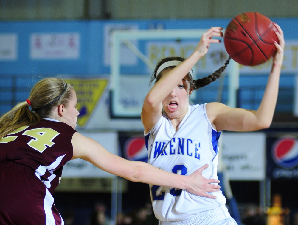 Thornton Academy forward Ashley Howe, left, defends against Lawrence forward Paige Belanger during the Class A state championship game Saturday at the Augusta Civic Center..