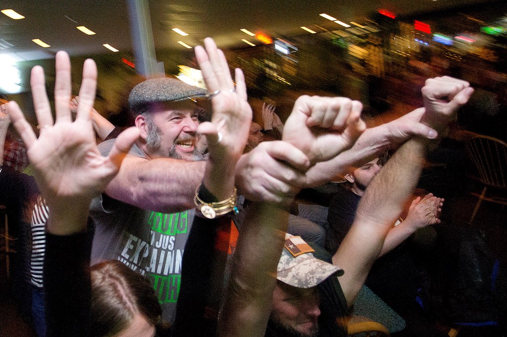 Dan Foley, center, a "Survivor" contestant, celebrates during a viewing party at Thatcher’s Restaurant & Sports Pub in South Portland for Wednesday night's double episode.