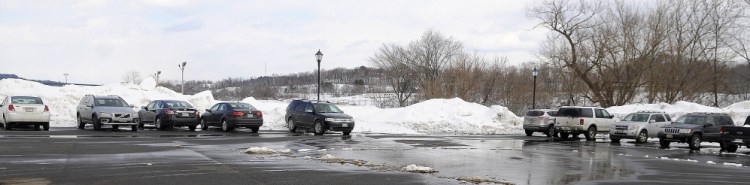 Some of the 11 cars parked at Mill Park to alleviate parking concerns at Capital Judicial Center in Augusta on Monday.