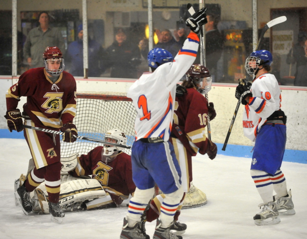Lawrence/Skowhegan players Andrew Carpenter, center, and Cody Martin, right, celebrate after a second period goal against Thornton Academy earlier this season. Martin was named a Travis Roy Award semifinalist on Tuesday.