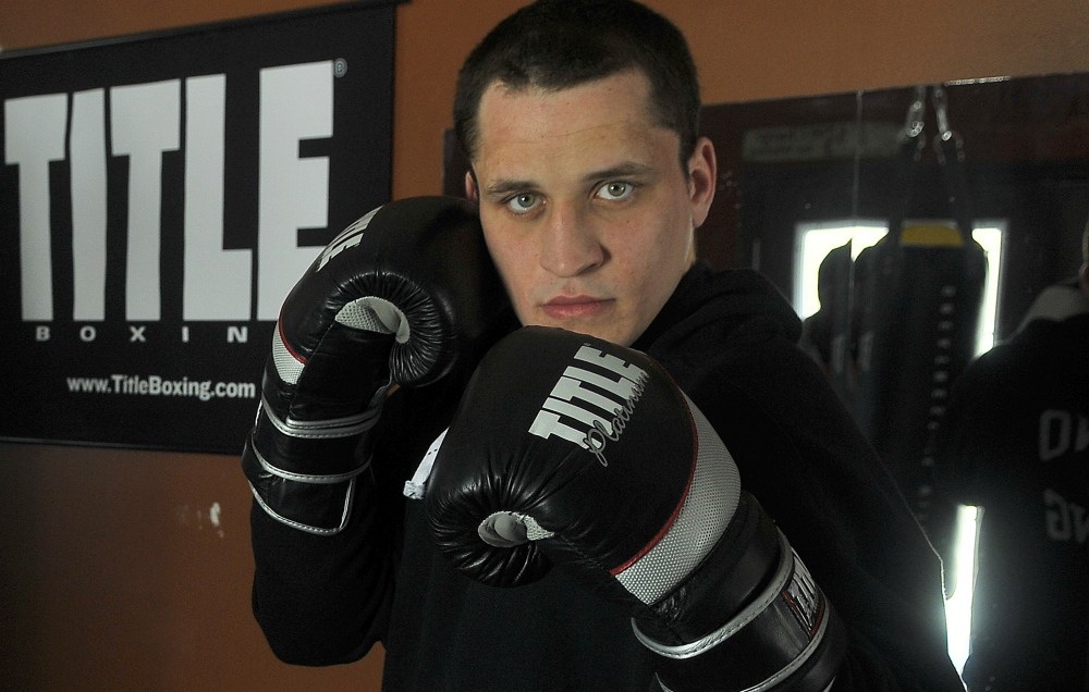 Justin Rolfe works out in his Fairfield home gym Feb. 27.