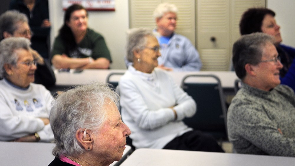 Residents of Chateau Cushnoc in Augusta listen to Augusta elementary school students sing in French on Tuesday.