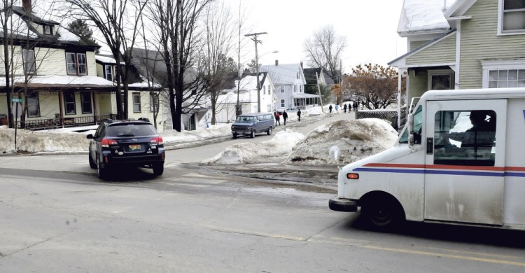 Vehicles turn onto Quebec Street off Perham Street in Farmington on Tuesday. Members of the Farmington Planning Board will meet at the intersection next week to observe a large truck negotiating the intersection to see what effect many trucks delivering wood chips to the nearby biomass boiler system planned by the University of Maine in Farmington would have on the neighborhood.