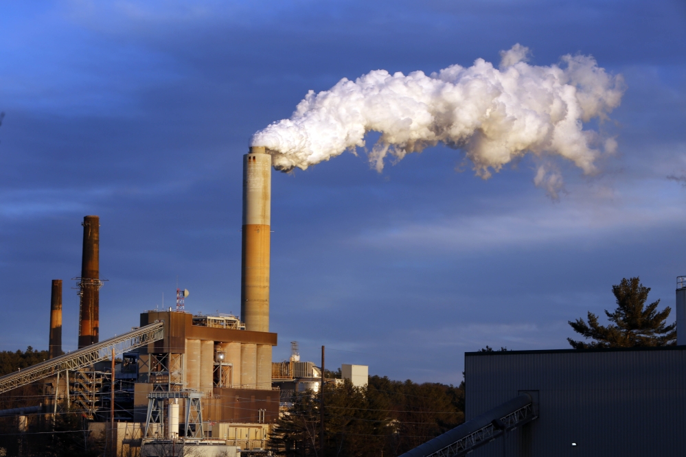 FILE - In this Tuesday Jan. 20, 2015 file photo, a plume of steam billows from the coal-fired Merrimack Station in Bow, N.H. New Hampshire’s largest utility, Eversource Energy, announced Thursday March 12, 2015 that it has has agreed to sell its power plants. Eversource will sell its nine PSNH hydro facilities and three fossil fuel plants, including the Merrimack Station in Bow, Newington Station and Schiller Station in Portsmouth.