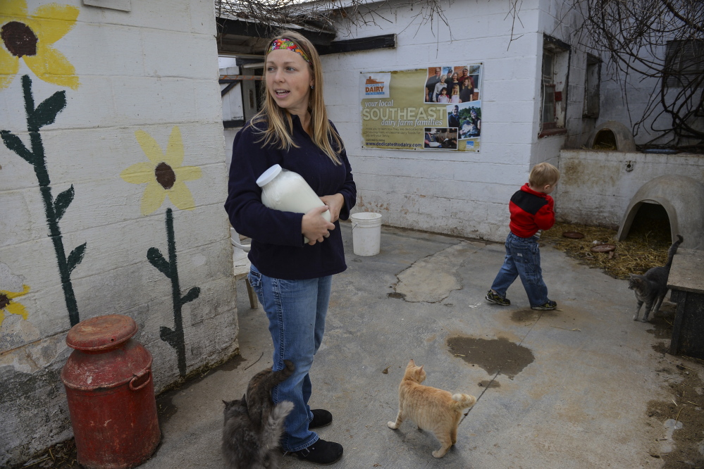 2014 Washington Post File Photo/Ricky Carioti
Jen Bernick and son Solomon of Winchester, Va., pick up a gallon of raw milk at Hedgebrook Farm in Winchester. The sale of some form of raw milk is legal in 26 states.