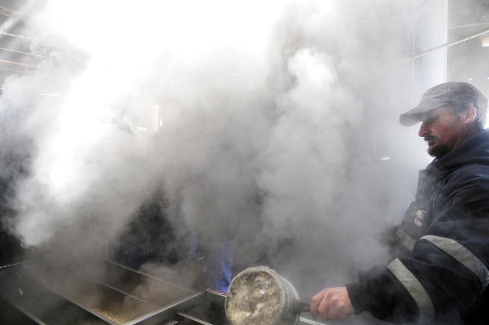 Jason Smith checks evaporating sap on Sunday at his family’s sugar shack, Mike’s Maple House, in Winthrop. The Smith family hosted the public on Maine Maple Sunday.