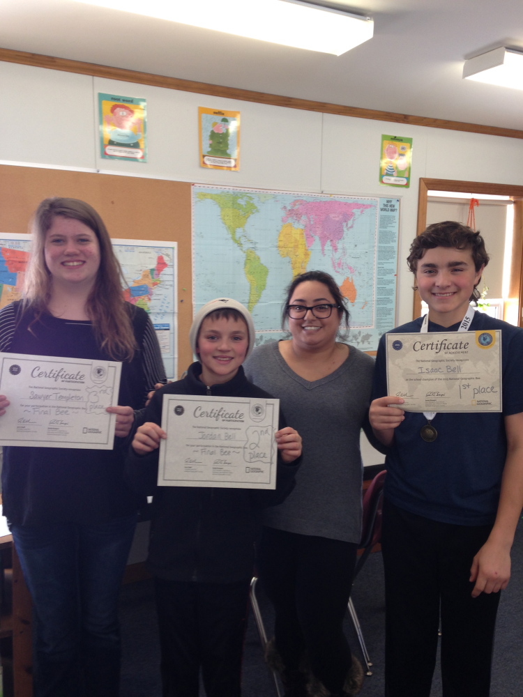 School-level National Geographic Bee, from left, were Sawyer Templeton, third place; Jordan Bell, second; Hannah Sher, moderator; and Isaac Bell, first.