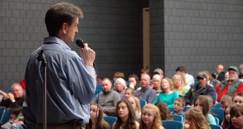 Bob Stuart, executive director of Maine College Circle, speaks on Tuesday at Skowhegan Area High School at a ceremony giving elementary school pupils their first college scholarship money. It is part of a program designed to get families thinking about college for their children at an earlier age in the hope that more Maine students will go on to higher education.