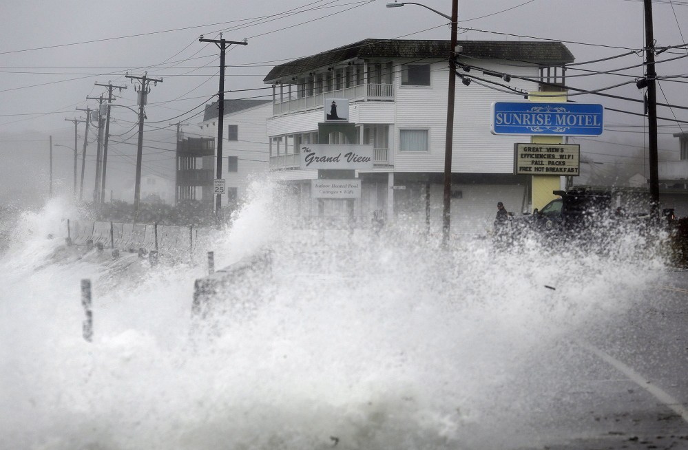 Derek Davis/Staff Photographer:  Waves crash over a sea wall along Long Beach Avenue in York, Monday, Oct. 29, 2012, as a result of weather conditions from Hurricane Sandy.