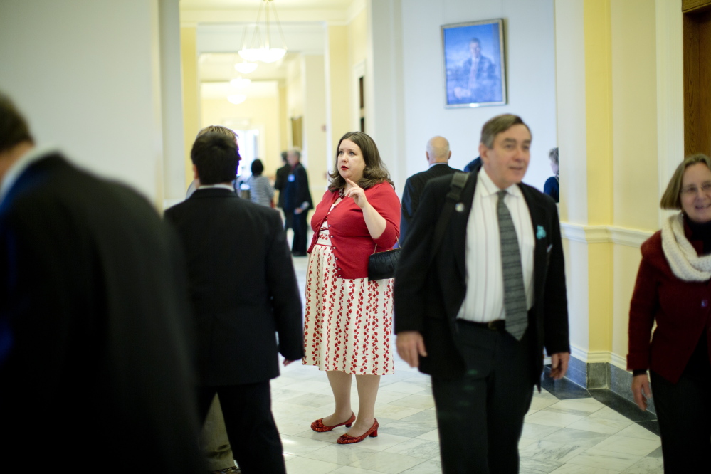 State Rep. Diane Russell speaks with constituents in a State House hallway. Russell has long been a Democratic Party leader on medical marijuana. She staked out her position early, when the issue was much more controversial, doing so at the risk of becoming an outsider.