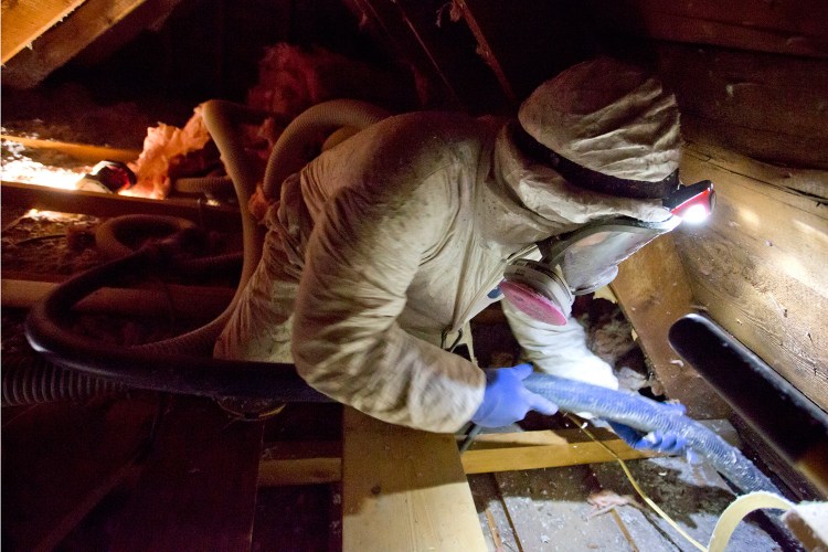 Steve Drake with Evergreen Home Performance blows cellulose insulation into the attic of Jim Johnson's home in Portland on Wednesday. Johnson and his wife, Lydia Moland, went ahead with the project to help their drafty house with the help of a $2,000 rebate program from Efficiency Maine. The state Public Utilities Commission decided this week to cap Efficiency Maine's funding at $22 million for the fiscal year beginning in July 2016, rather than the $60 million the Legislature apparently intended.