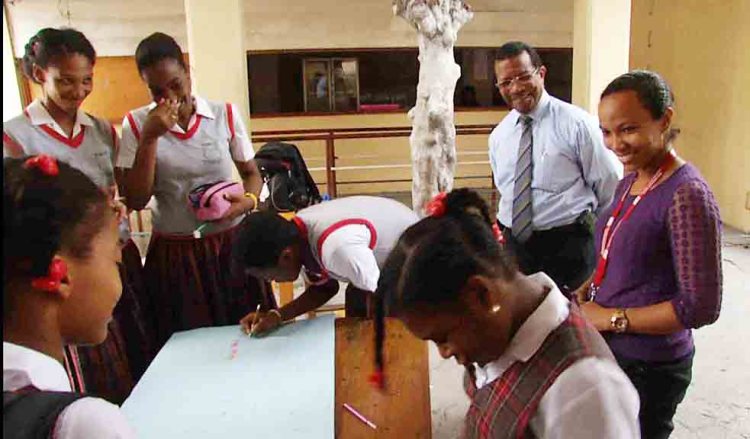 Headmaster and chemistry teacher Guy Etienne, in shirt and tie, watches a group of high school students work on a project at College Catts Pressoir in Port-Au-Prince, Haiti. Varkey Foundation photo