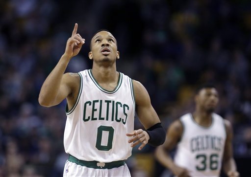 Boston Celtics guard Avery Bradley points upward after scoring against the Miami Heat  in Boston Wednesday. Celtics guard Marcus Smart (36) is in background. (AP Photo/Elise Amendola)