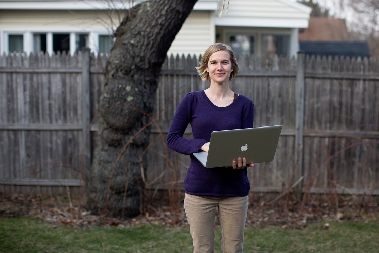 Misty McLaughlin the backyard at her house in South Portland. McLaughlin is a nonprofit consultant and user experience architect who has the ability to work remotely.